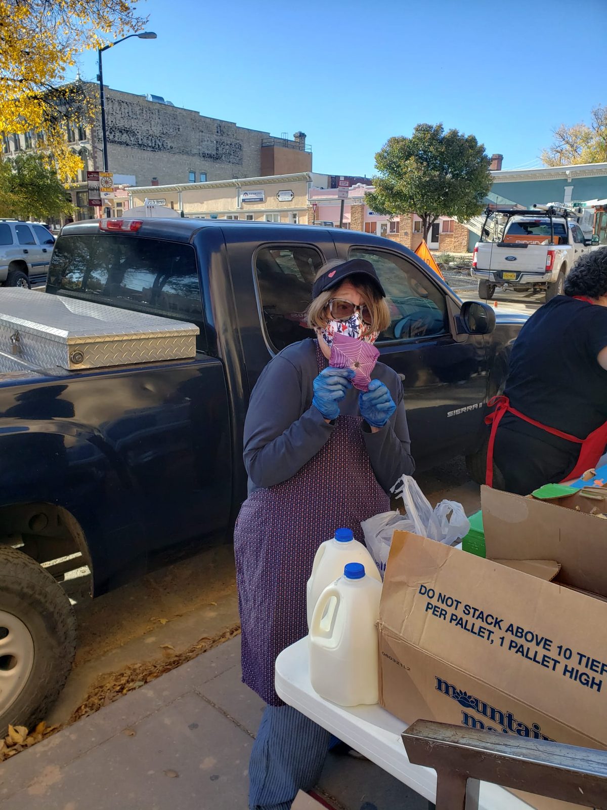 A volunteer helping distribute groceries and supplies to the community